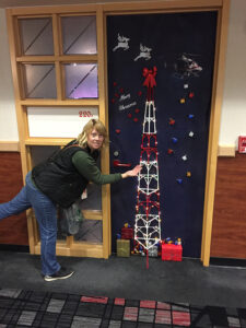 Corp's Amy Trudo shows off her great work on the CBC Suite door at the PNC Arena.